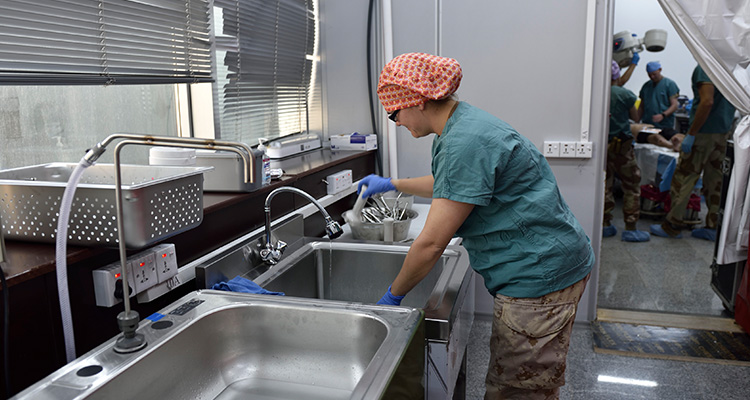 Operating Room Tech washing in sink