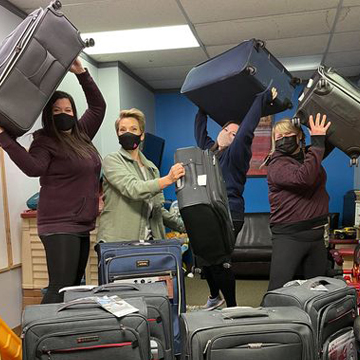 Students with suitcases for kids from bottle drive