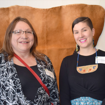 Artists Ruby Sweetman and Amy Malbeuf posing in front of their art piece