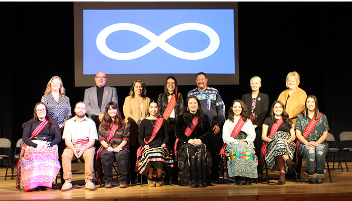 Award winners on stage with dignitaries and speakers